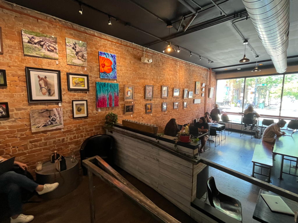The interior seating areas and art gallery inside The Upside Brew in Cincinnati