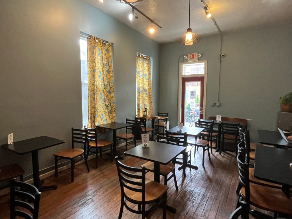 The sunlit main seating area inside of Sidewinder Coffee
