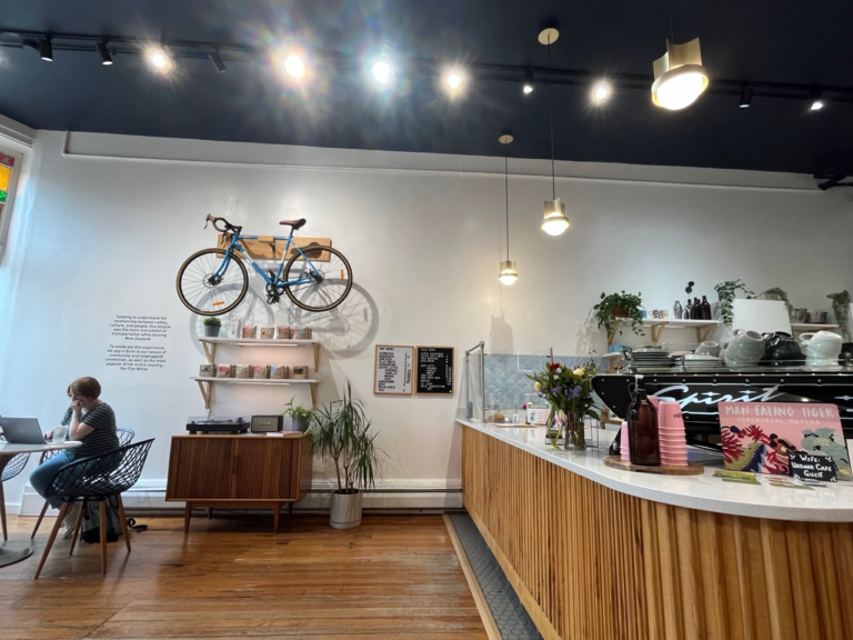 A blue bicycle hanging on a wall above the ordering counter inside Urbana Cafe in East Walnut Hills