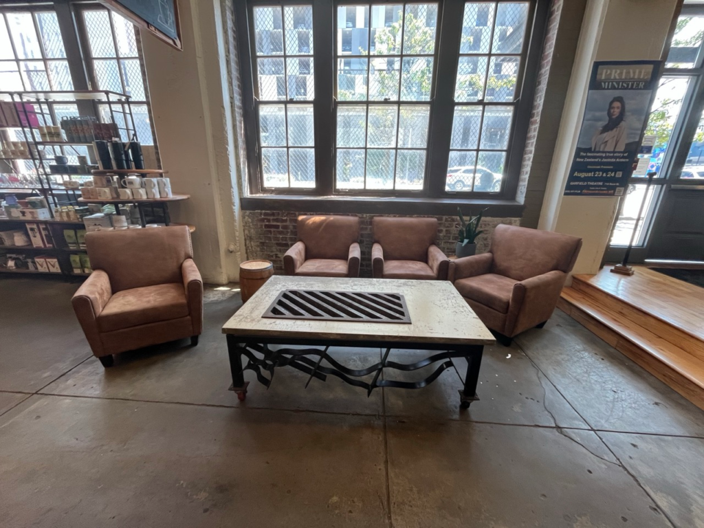 Four leather chairs around a wooden coffee table inside Coffee Emporium in Over the Rhine