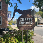 Outdoor sign shaped like a coffee pot that says "Coffee Emporium"