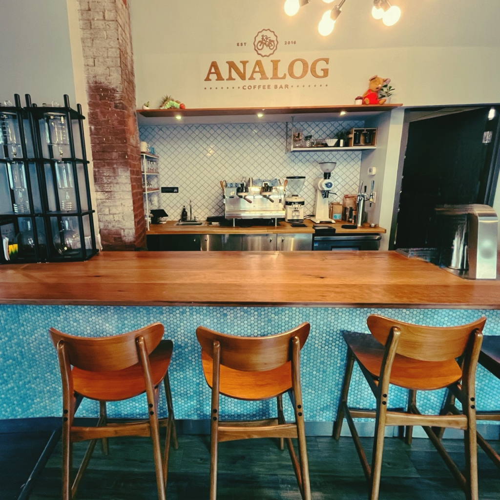 The Analog Bar inside Carabello Coffee Company with a blue-tiled and wood-topped counter